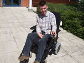 Pupil on his wheelchair outside