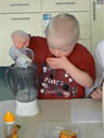 Child putting water Into Blender