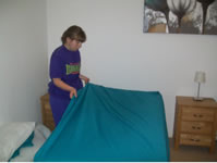 Student making a bed in the flat