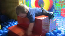 Pupil in a soft play ball pit